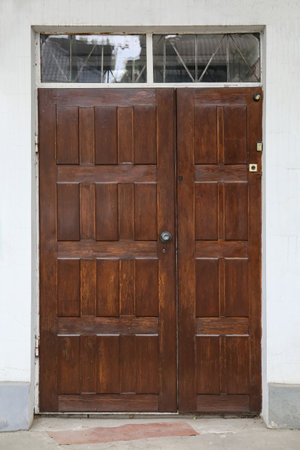 Building with wooden door and transom window