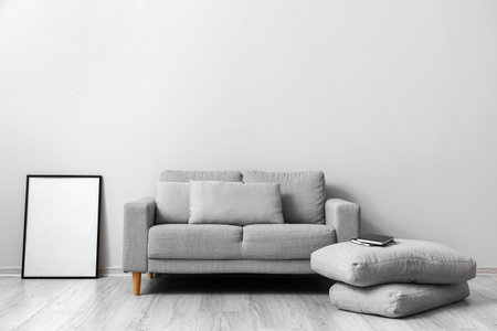 Comfortable sofa with pillows on wooden floor in living roomの写真素材