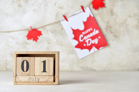 Wooden cube calendar with date JULY 1 on light background. Happy Canada Dayの写真素材