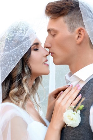 Happy young bride with her groom outdoors