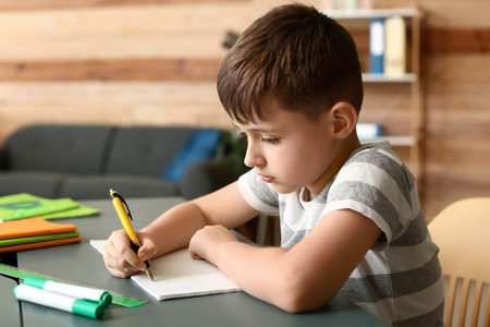 Little boy doing homework in the roomの写真素材