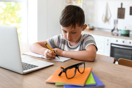 Little boy doing homework in the roomの写真素材