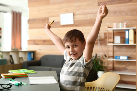 Little boy doing homework in the roomの写真素材