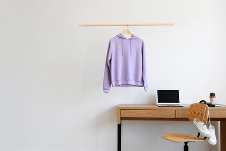 Workplace near wall with hanging hoodieの写真素材