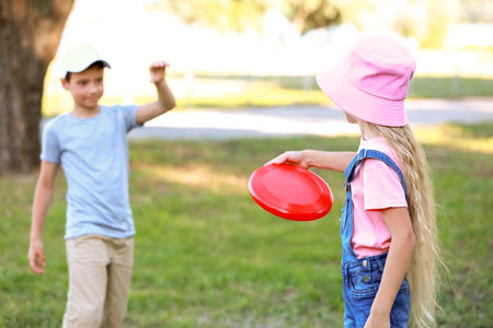 Cute little children playing flying disc outdoorsの写真素材