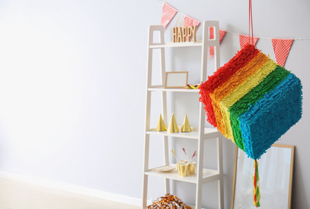 Mexican pinata hanging in light room decorated for Birthday partyの写真素材