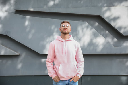 Young guy in stylish hoodie outdoors