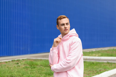 Young guy in stylish hoodie outdoors