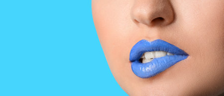 Beautiful young woman with unusual makeup on color background, closeupの写真素材