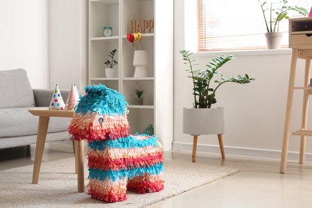 Mexican pinata and table with party hats in living room