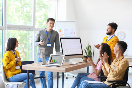 Young business people clapping during meeting in officeの写真素材