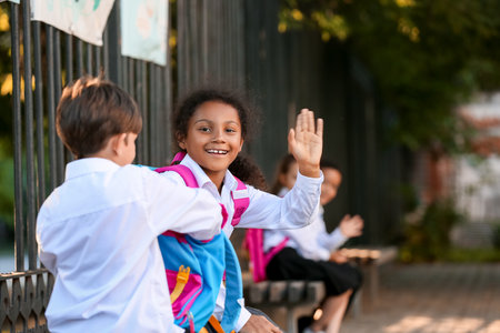 Cute little pupils meeting after summer holidays. back to schoolの写真素材