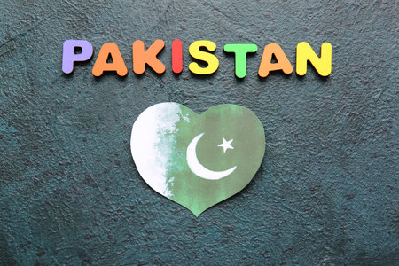 Flag of Pakistan in shape of heart on dark backgroundの写真素材