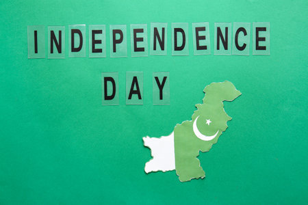 Flag map of Pakistan and text INDEPENDENCE DAY on color backgroundの写真素材