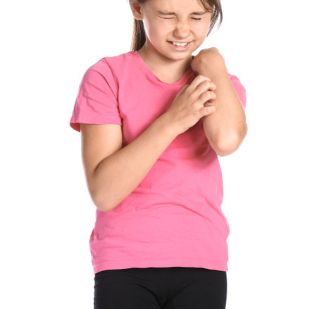 Little girl scratching herself on white background