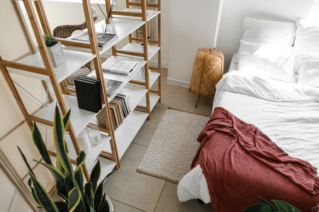 Interior of light bedroom with wooden book shelvesの写真素材