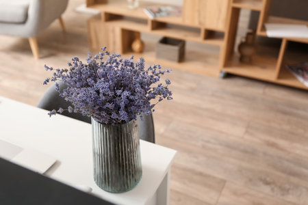 Vase with beautiful lavender flowers on table in roomの写真素材
