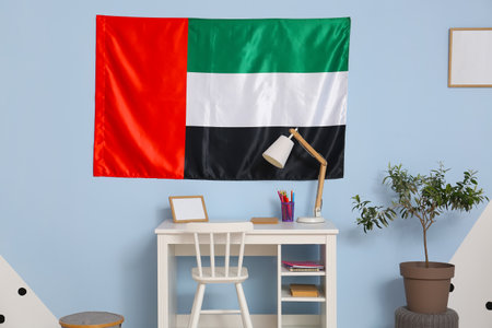 Interior of stylish children's room with desk and hanging UAE flagの写真素材