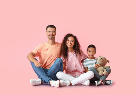 Happy interracial family on color backgroundの写真素材