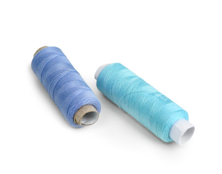 Blue thread spools isolated on white background