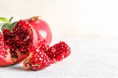 Fresh ripe pomegranates on light backgroundの写真素材