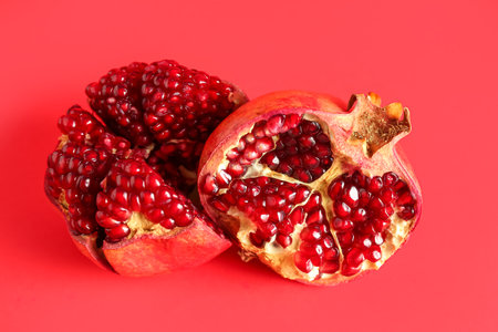 Fresh pomegranates on red backgroundの写真素材