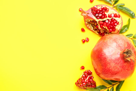 Fresh ripe pomegranates on yellow backgroundの写真素材
