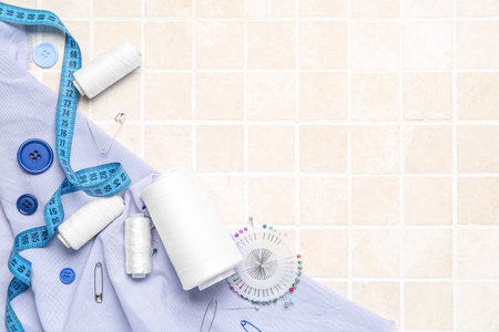 Composition with sewing supplies on light tiles