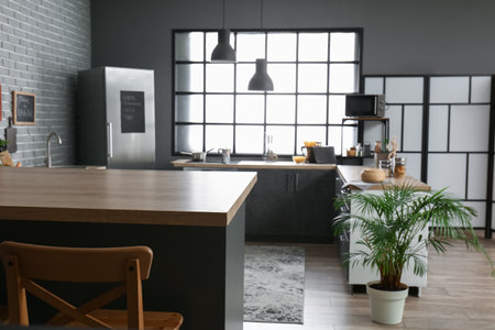Interior of modern kitchen with bar counter and wooden chairの写真素材