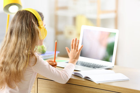 Little girl studying online at home