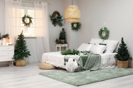 Interior of bedroom with Christmas mistletoe wreaths and fir treesの写真素材