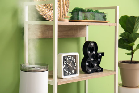 Book shelf with clock and decor near color wall