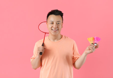 Sporty male badminton player on color backgroundの写真素材