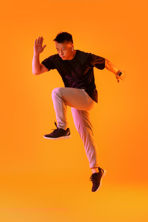 Sporty male runner on color background