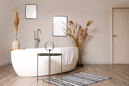 Interior of light bathroom with dry reeds in vasesの写真素材