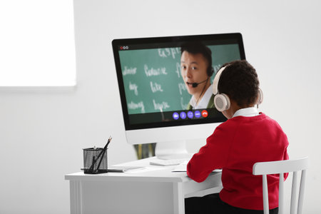 Little African-American boy studying online at homeの写真素材