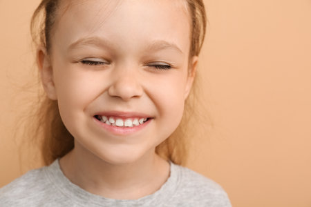 Portrait of happy little girl on color background