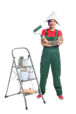 Female painter with paper hat, paint roller and ladder on white backgroundの写真素材