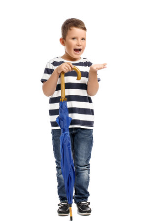Cute little boy with blue umbrella on white backgroundの写真素材
