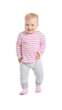 Cute baby girl learning to walk on white backgroundの写真素材