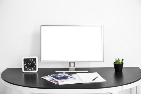 Stylish home workplace with computer near white wall in roomの写真素材