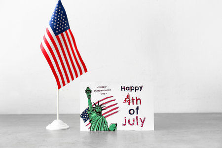 Greeting card for Independence Day and American flag on light backgroundの写真素材