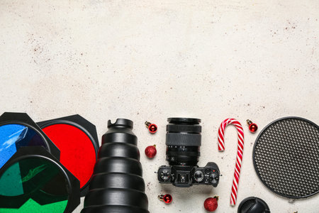 Photographer's equipment with Christmas balls and candy cane on white background