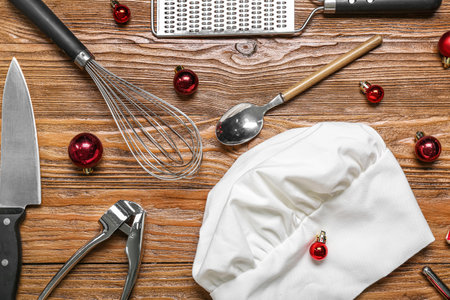 Chef's hat with utensils and Christmas balls on wooden backgroundの写真素材