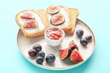 Plate of tasty bruschettas with cream cheese and figs on color backgroundの写真素材