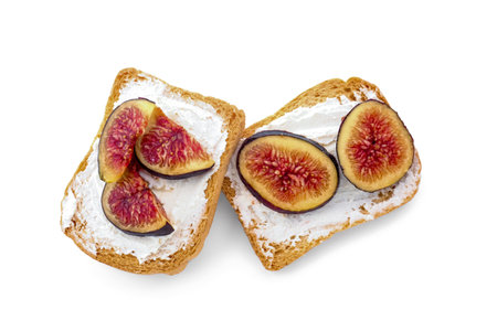 Tasty bruschettas with cream cheese and figs on white backgroundの写真素材