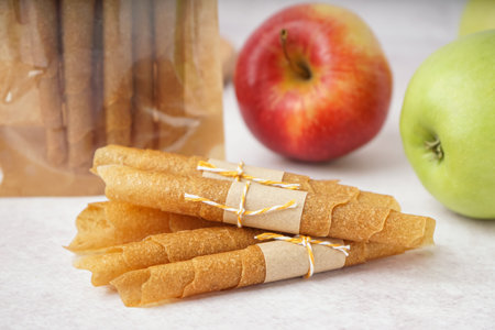 Heap of tasty apple pastilles on light tableの写真素材