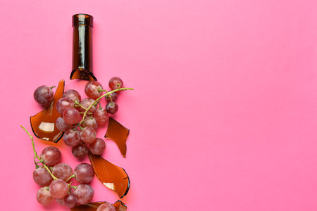 Composition with grape and broken bottle on color background, closeupの写真素材