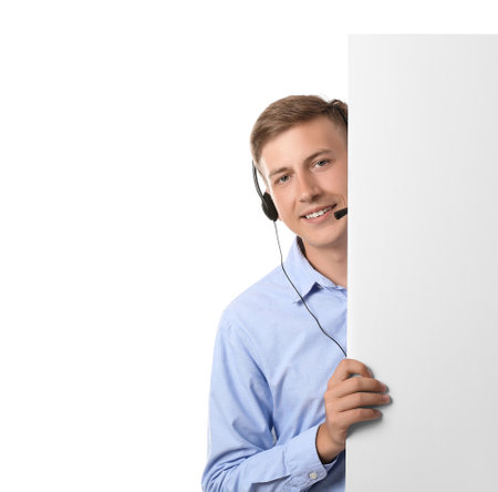 Young consultant of call center in headset with blank paper sheet on white backgroundの写真素材