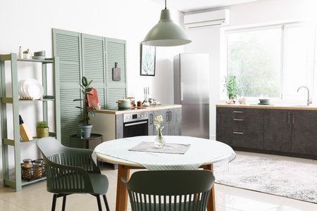 Dining table with chairs in modern interior of kitchen